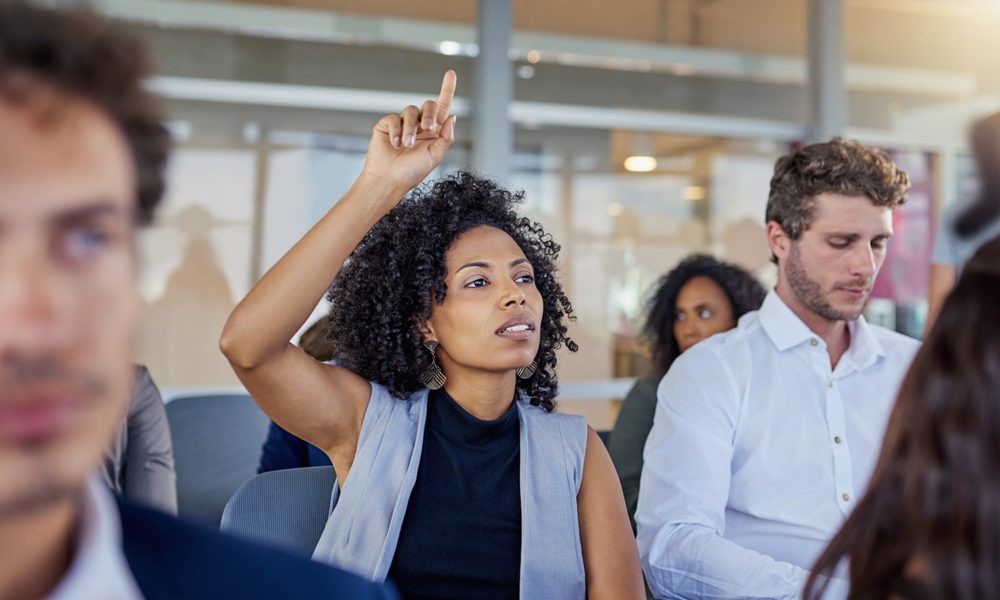 Woman raising hand at meeting