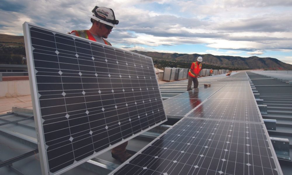 Workers installing solar panels