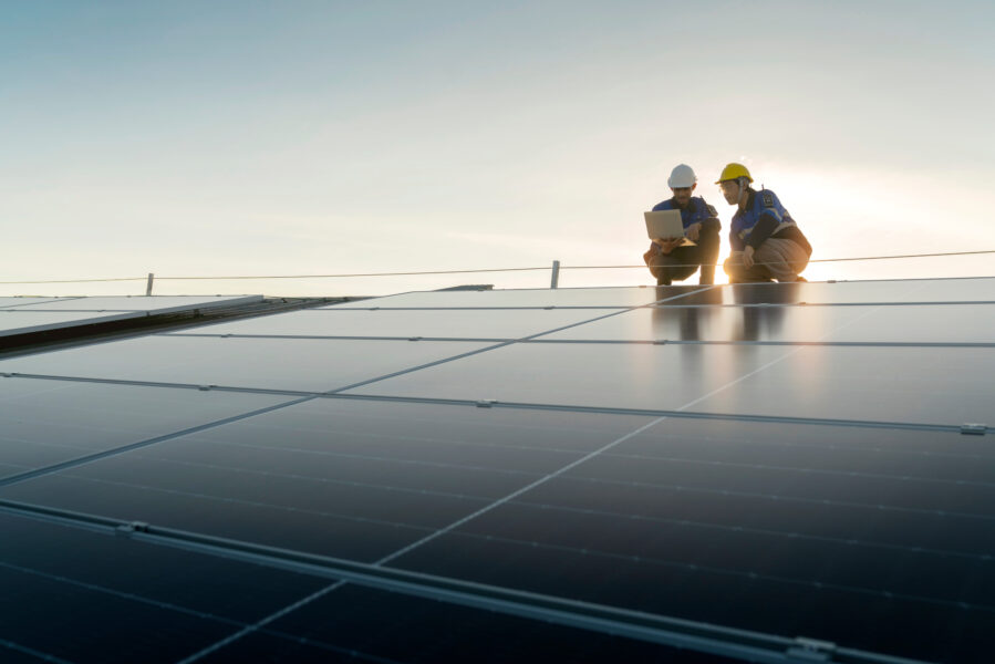 Two people installing solar panels