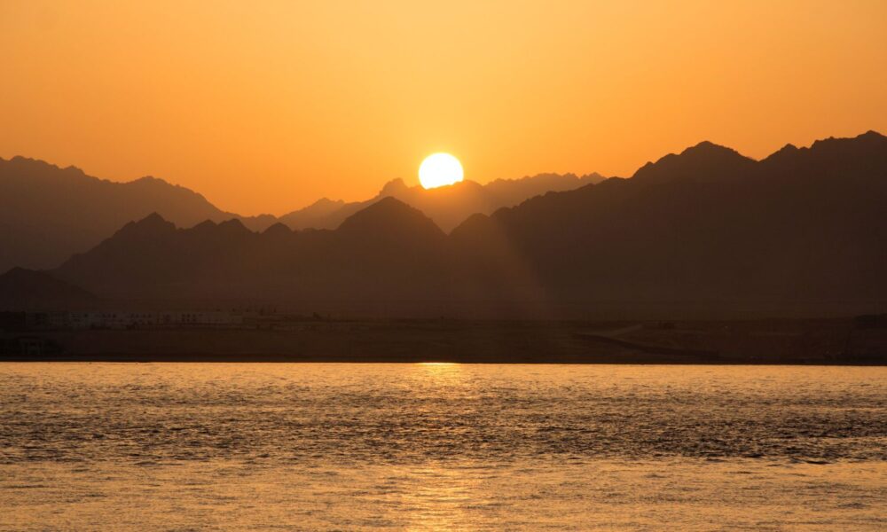 The sun rises over mountains and ocean in the Eygptian resort town of Sharm el-Sheikh, site of the 2022 UN COP27 conference