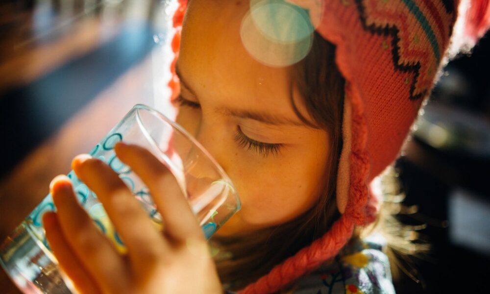 Girl with red hat drinking water