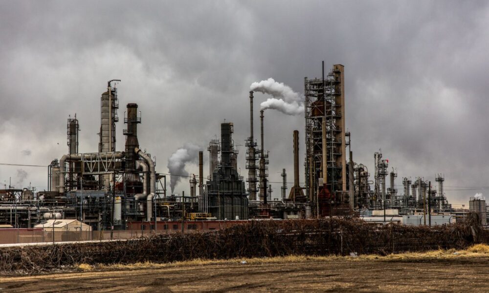 A Utah power plant releases clouds of pollution gases under a moody gray sky