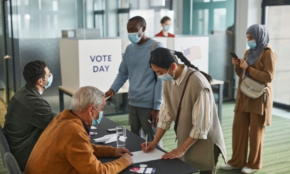 election workers with voters