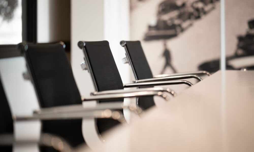 empty conference room chairs around a table