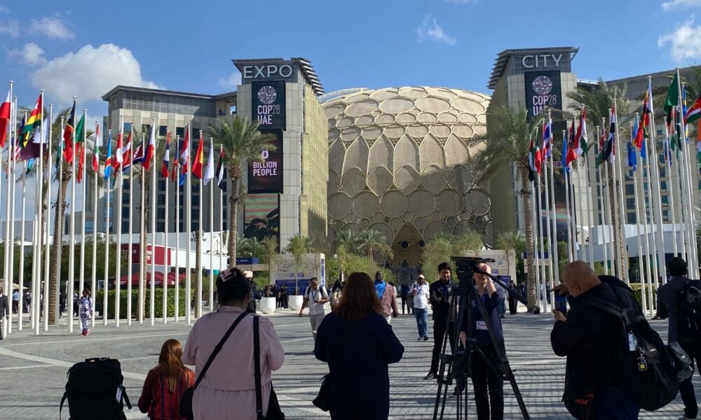 A press conference takes shape outside of Expo City, a COP28 venue in Dubai, UAE.