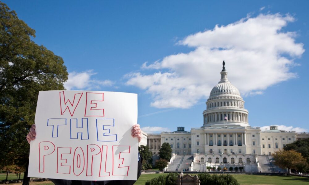 We the people sign outside US Capitol