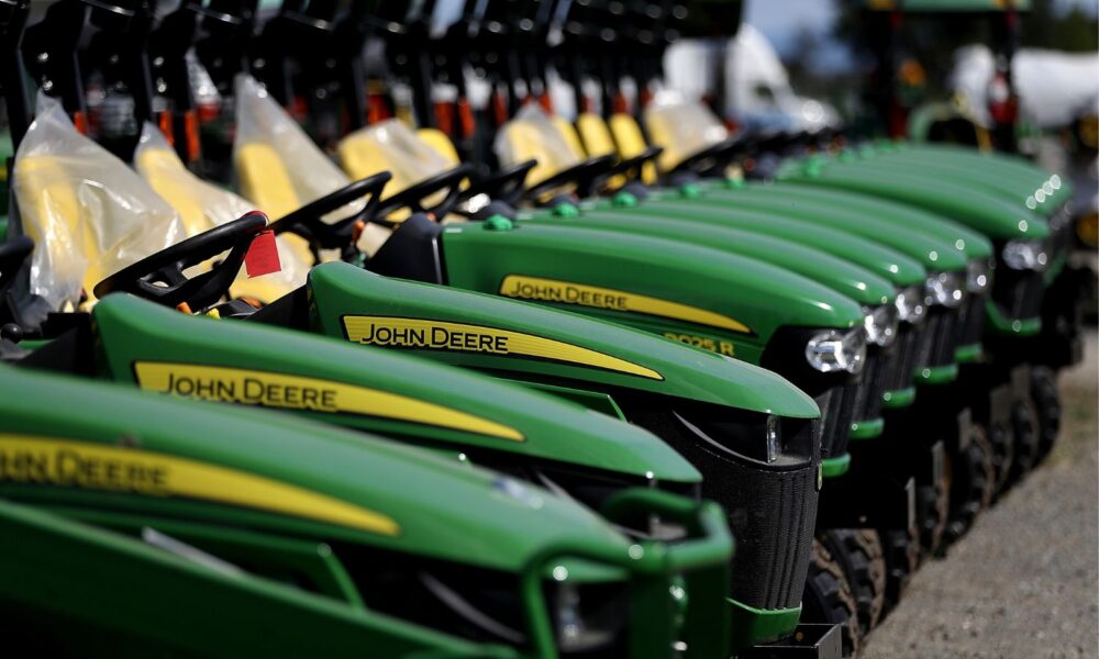 line of John Deere tractors on display