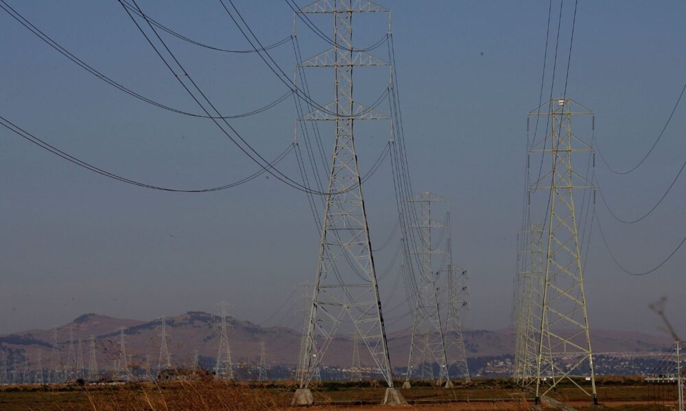 Power towers line a highway in Vallejo, CA.