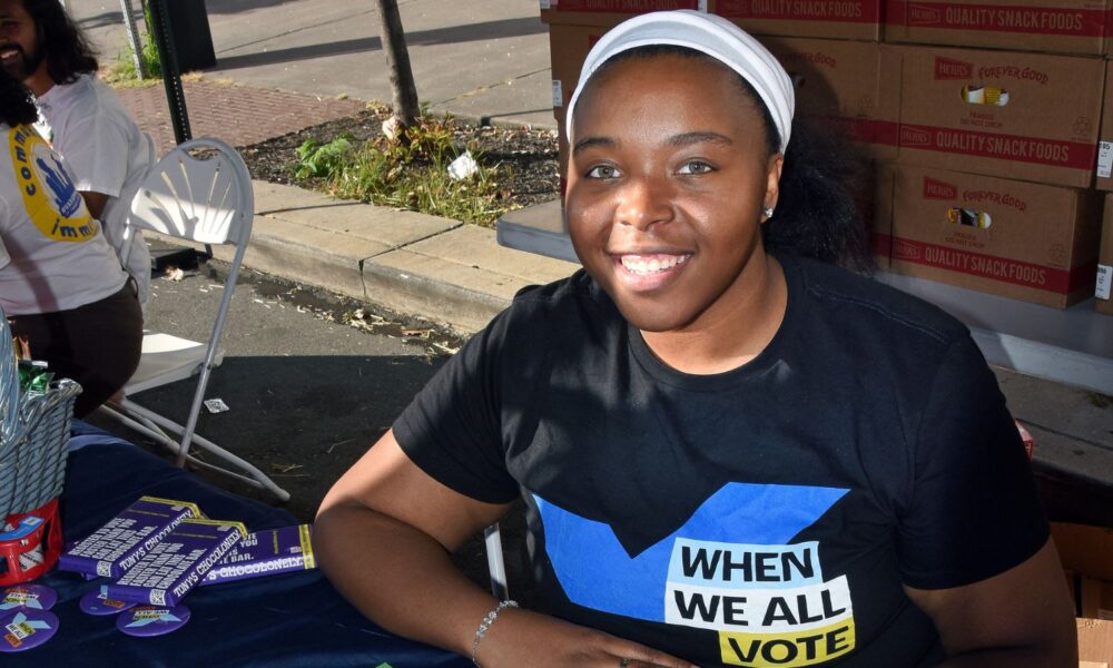 A woman at a voting information booth.