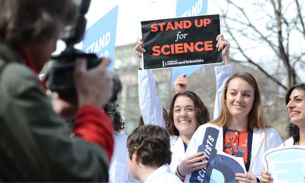 UCS President Gretchen Goldman holds a sign at the AAAS Stand Up for Science Rally in Boston in 2017.