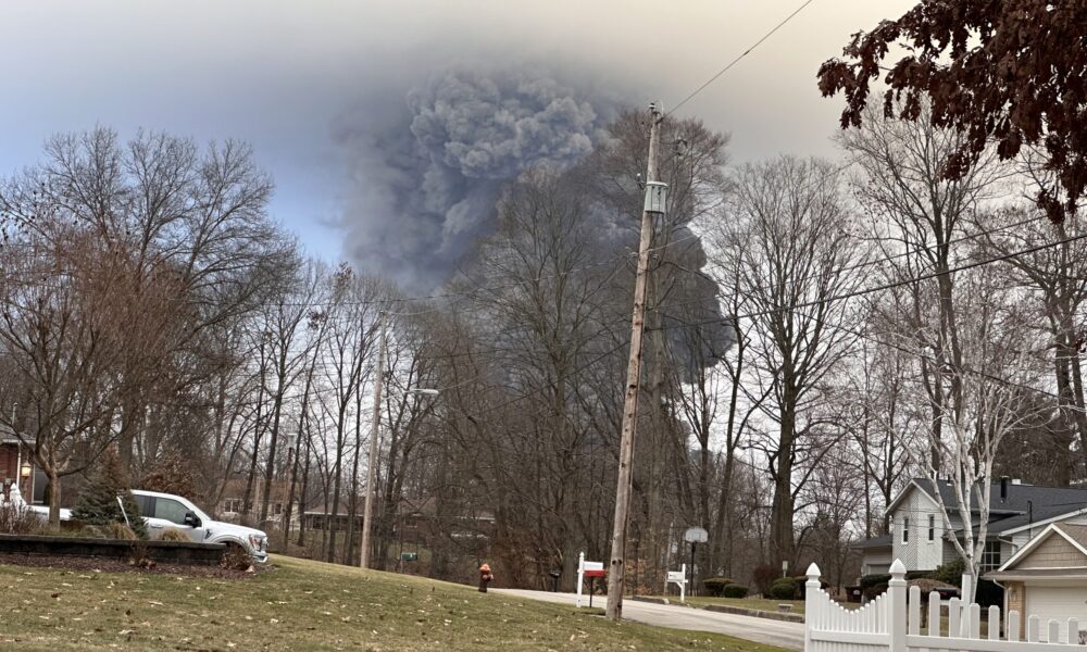 a cloud of smoke seen from a neighborhood in East Palestine, Ohio after a train derailment.