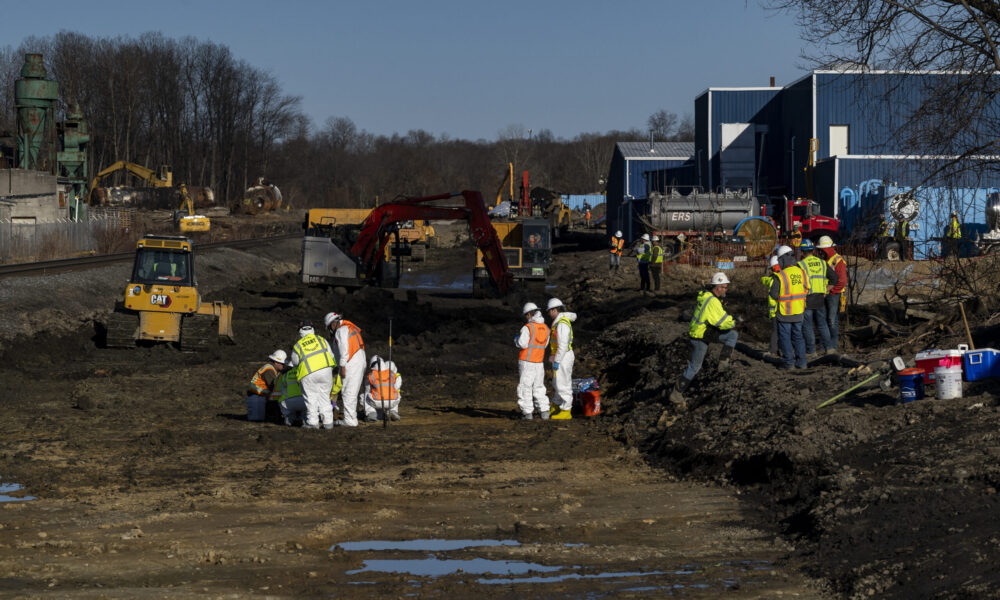 a cleanup crew monitors a field near the East Palestine, Ohio train derailment site.