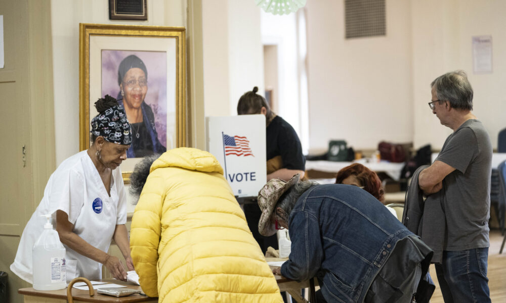 poll workers assist voters at a Detroit voting location