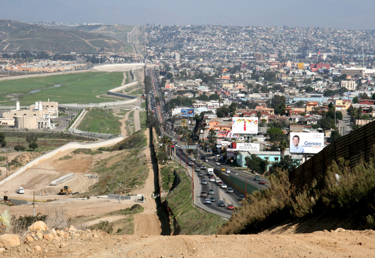 a fence separating the Tiajuana, Mexico, and US border in San Diego, CA