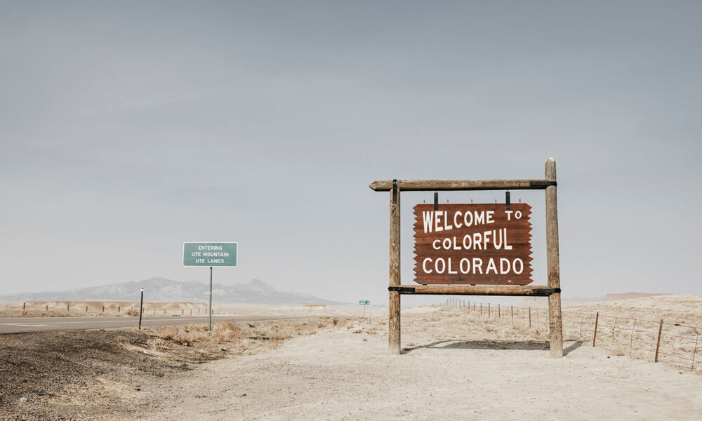 a wooden welcome to colorful Colorado sign near the Ute Mountain Lands