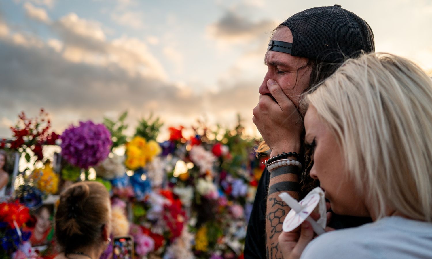 Community members grieve the lives lost to flooding in Texas' Hill Country at a vigil.