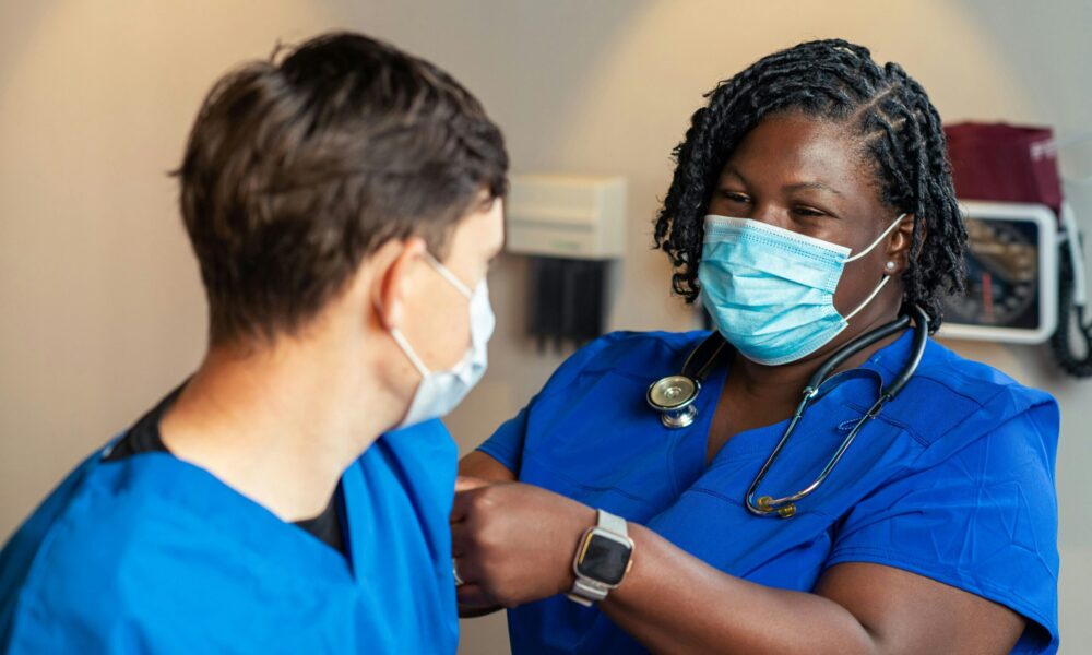 a nurse bandages a patient after a vaccination