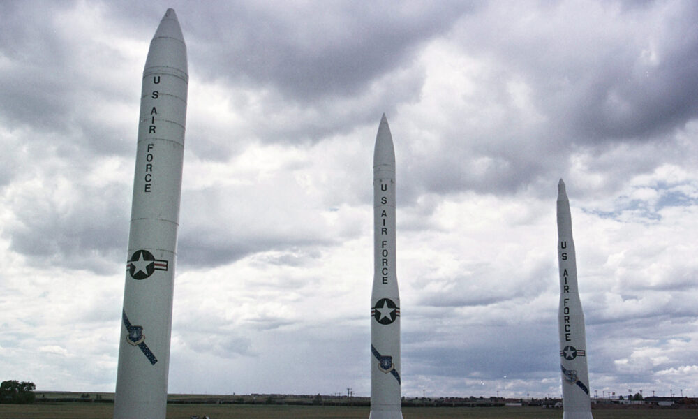 Three different US ICBMs on display at an Air Force base under a cloudy sky