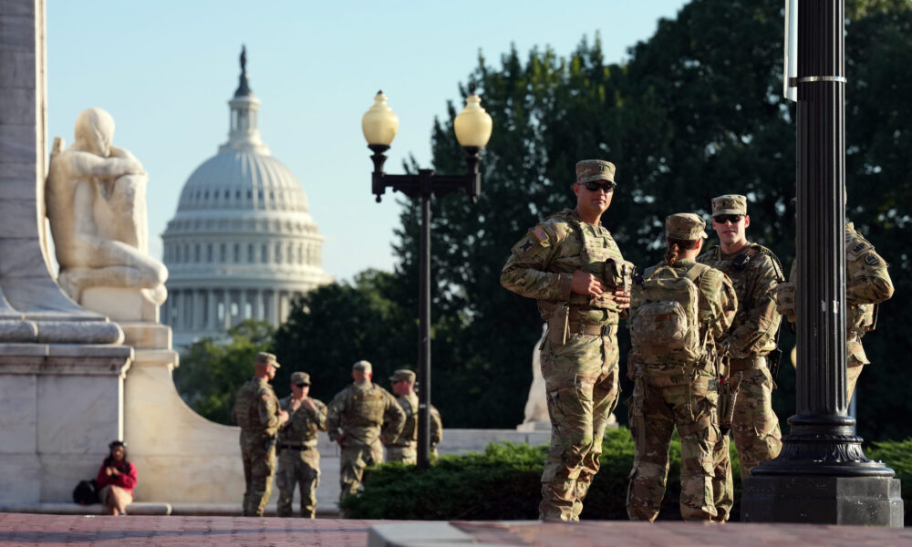national guard troops standing in Washington DC with the capitol visible in the background