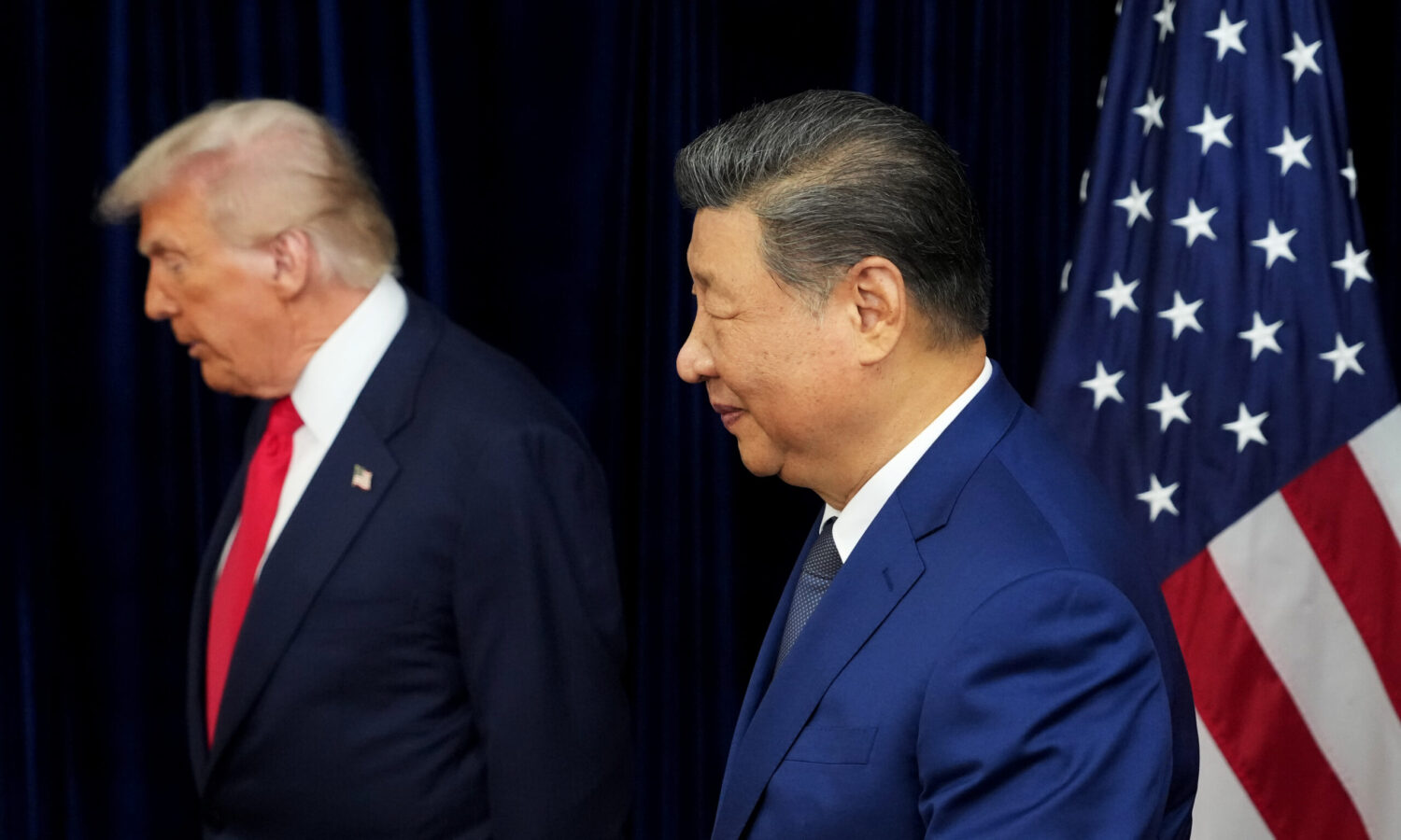 photo of US President Trump and Chinese President Xi in profile against a dark background; a US flag is to the right of the men
