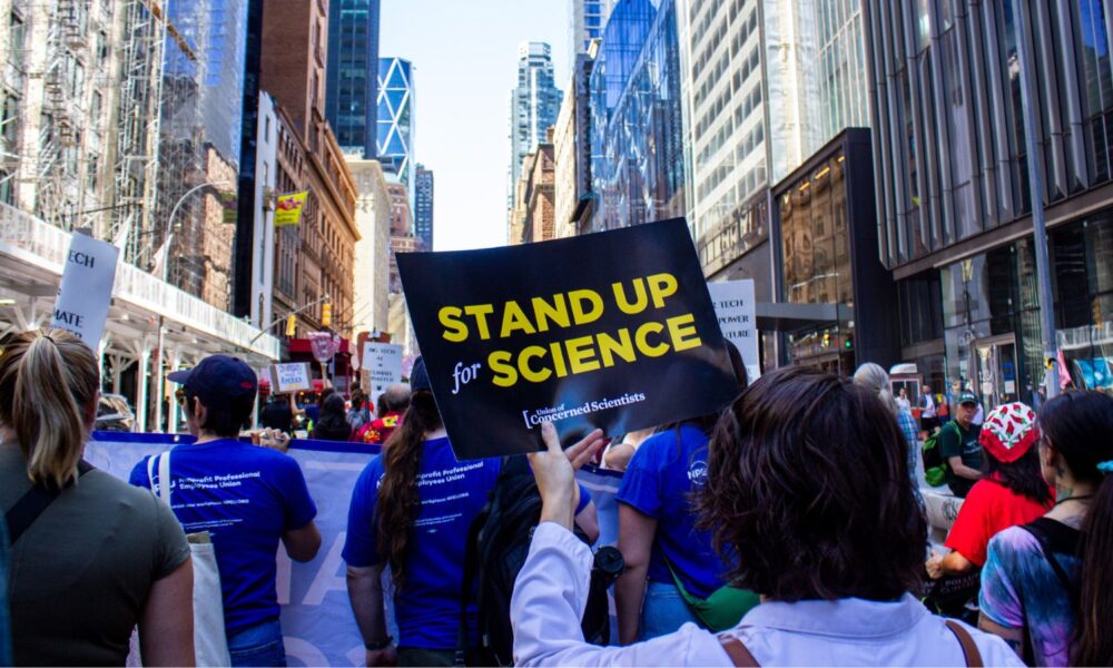 UCS President Gretchen Goldman holds a sign reading Stand up for Science at a march in NYC during Climate Week 2025