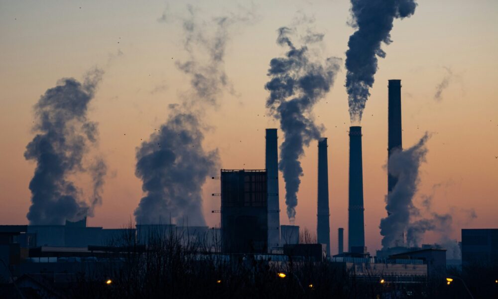 emissions come out of smokestacks at an industrial facility