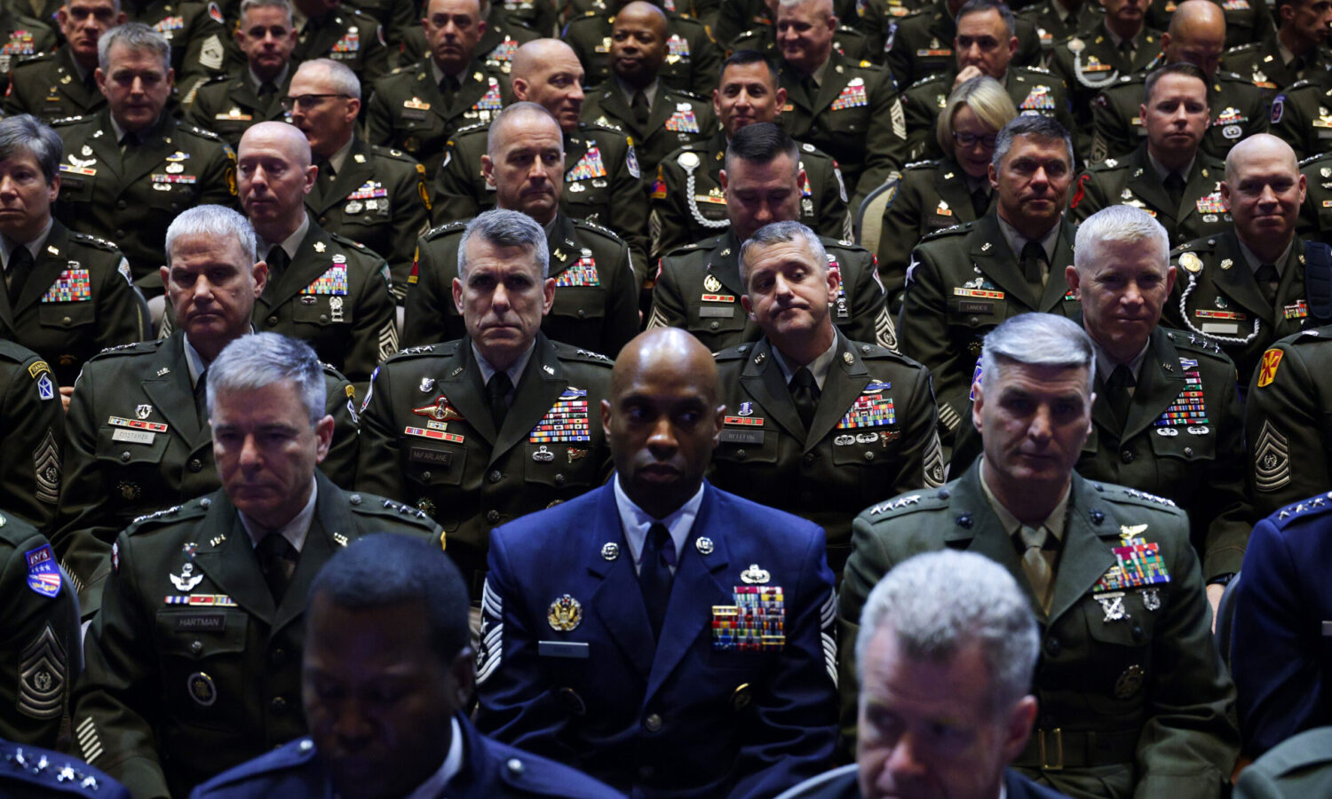 photo of a large group of generals from different branches of the military sitting in rows and listening to a speech