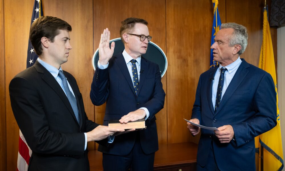 Jim O'Neill being sworn in by Robert F. Kennedy Jr