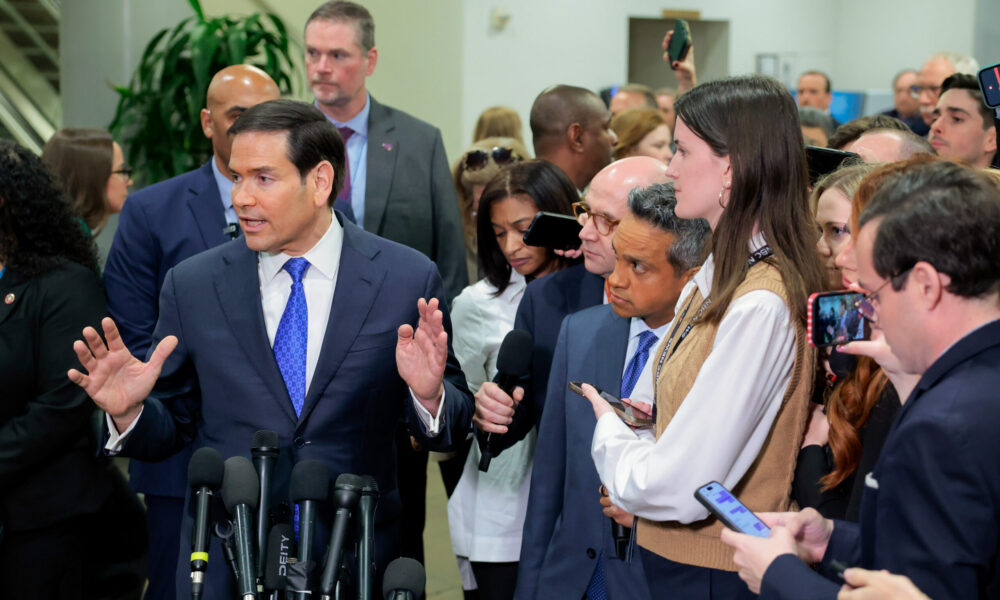 photo of US Secretary of State Marco Rubio speaking with a large group of reporters