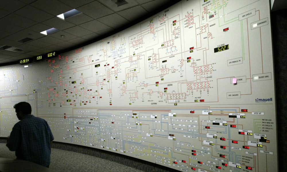 A floor-to-ceiling map board shows power distribution through California's electrical grids in the control center of the California Independent System Operator, CAISO, during a heat wave.