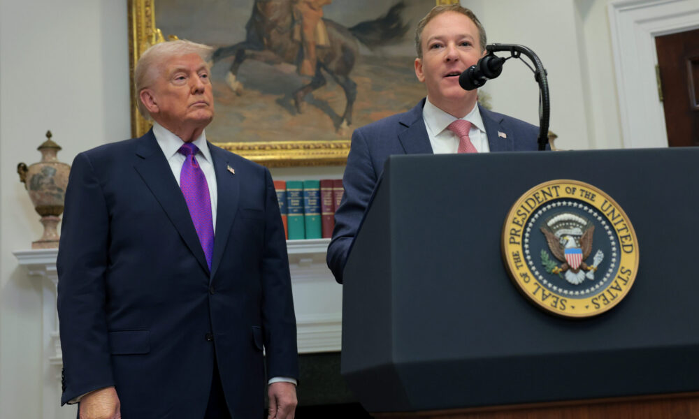 EPA Administrator Lee Zeldin speaks at a lectern at the White House with President Trump looking on
