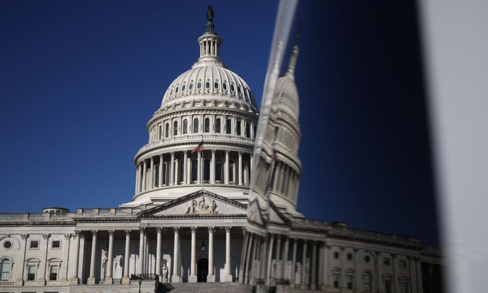 In a photo refraction, the US Capitol building is pictured in double, with the doubled image askew against a dark blue sky