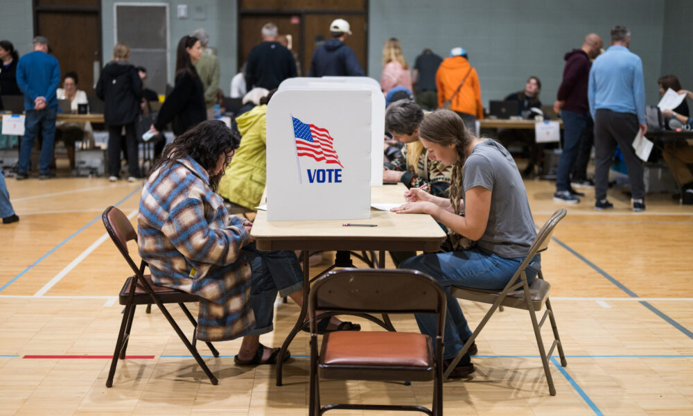 voters filling out ballots at an early voting center